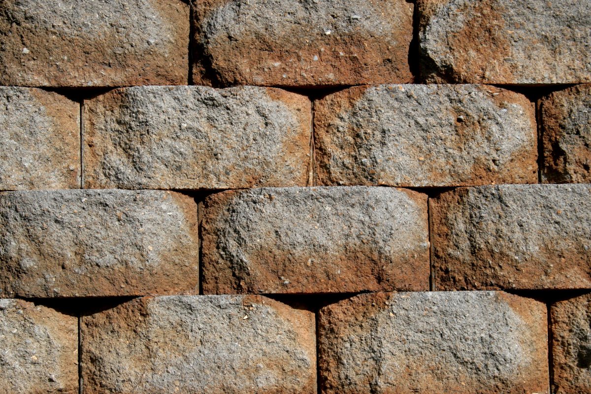 Cracked and leaning retaining wall showing structural failure at a residential property in Greater Binghamton NY after winter freeze-thaw damage