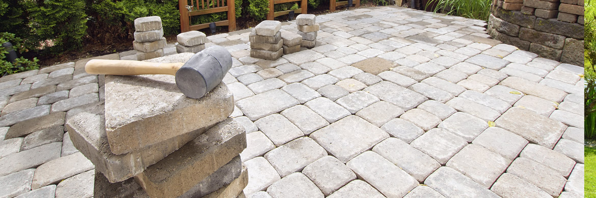 Professionally installed stone patio and retaining wall showcasing quality hardscape craftsmanship